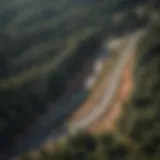 Aerial view of Pikes Peak Highway winding through lush forests.