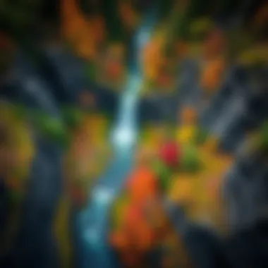 An aerial view of a waterfall nestled in a canyon, surrounded by a tapestry of colorful foliage.